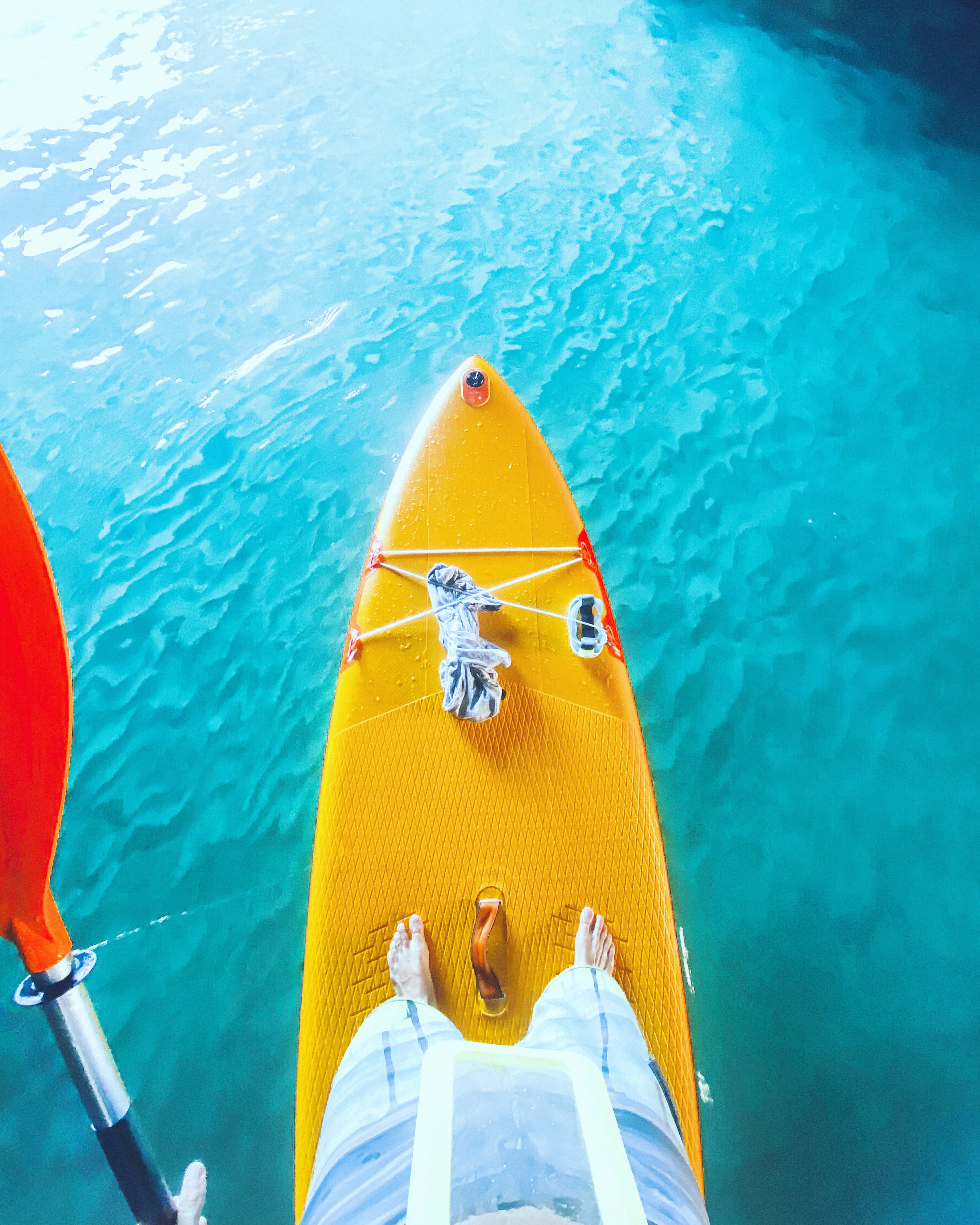 Stand-up paddleboard on turquoise water along the Galé coastline